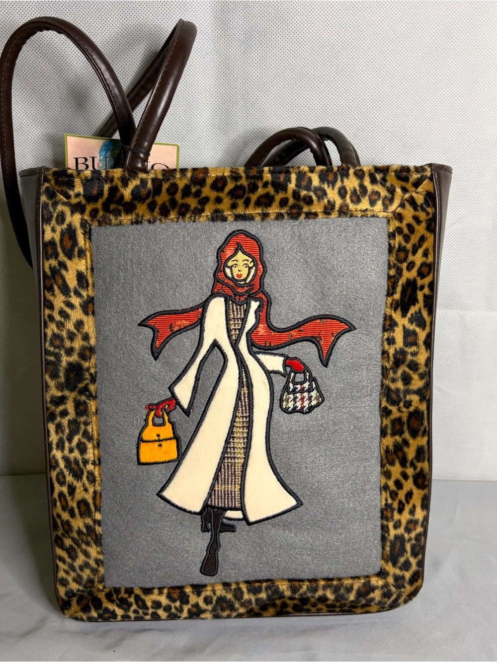 Bueno Totables Leopard-Trim Tote with Red-Scarfed Woman